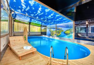 a large swimming pool in a house with a large ceiling at Domki Spa Resort Bukowiec in Bukowiec