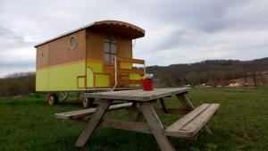 ein Spielhaus auf einem Picknicktisch auf einem Feld in der Unterkunft Véritable roulotte à la campagne in Bassillon-Vauzé + 2 Fotos
