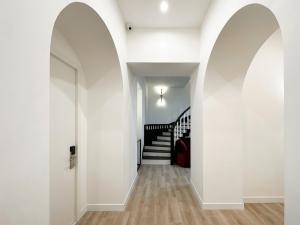 an arched hallway with white walls and a staircase at RIS Opera Apartments Yerevan in Yerevan