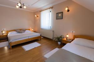 a bedroom with two beds and a window at Tourist farm Tominc in Brezje
