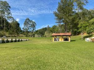 a gazebo in the middle of a grass field at Fascinação Café Hotel in Cunha