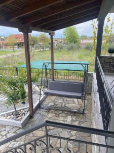 a bench sitting on a patio with a table at Villa Helen in Asprovalta