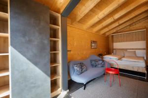 a room with a bed and a red chair at Achners Chalet am Forsthaus in Wallgau