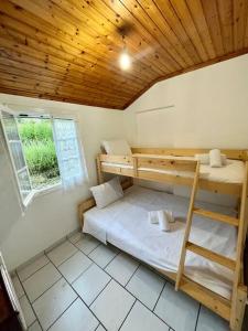 a room with two bunk beds and a window at Kikis Cottage in Antípaxos