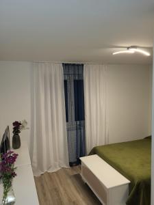 a bedroom with a bed and a table with flowers at Haus für vier, kinderfreundlich! in Steinhagen