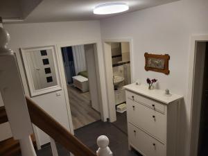 a white bathroom with a sink and a mirror at Haus für vier, kinderfreundlich! in Steinhagen +5 photos