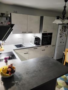 a kitchen with a bowl of fruit on a counter at Haus für vier, kinderfreundlich! in Steinhagen