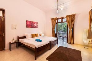 a bedroom with a bed and a large window at SaffronStays Chikoo Wadi- 3BDR Pet-friendly Villa with Pool in Boisar in Boisar +30 photos