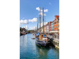 a group of boats docked in a canal with buildings at ApartmentInCopenhagen Apartment 1288 in Copenhagen