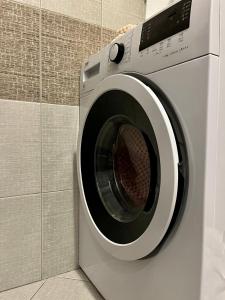 a washing machine is sitting in a bathroom at Megan's home in Koper