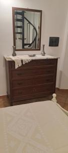 a dresser with a mirror on top of it at Domo Sarda in Orosei