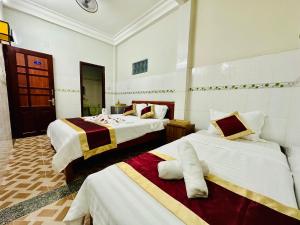 a hotel room with two beds in a room at DK House Homestay in Hoi An