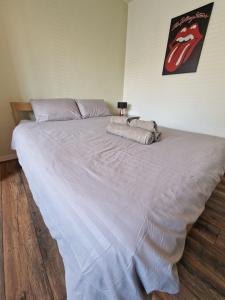a large bed in a bedroom with a large bedspread at Cozy room - Only room in London