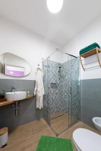 a bathroom with a glass shower and a sink at Dimora Il Parco in Bologna