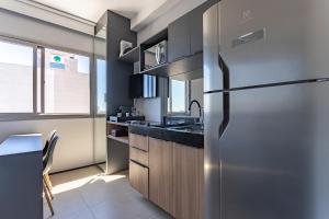 a kitchen with a stainless steel refrigerator and a sink at Studio confortável e moderno - Vn Vergueiro próximo a hospitais, universidades, a av Paulista e em frente ao centro cultural SP - excelente localização - ap 1515 in Sao Paulo
