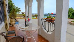a table and chairs on a balcony with a window at Buenavista de Illora Íllora by Ruralidays in Illora