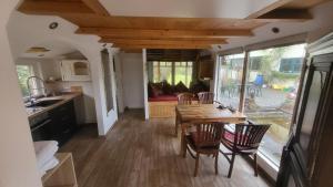 a kitchen and living room with a table and chairs at Seychellen House in Großenkneten +17 photos