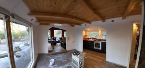 a kitchen is being remodeled with wooden ceilings at Seychellen House in Großenkneten