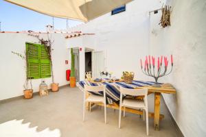 a dining room with a table and chairs at Calma Hotel in Ciutadella