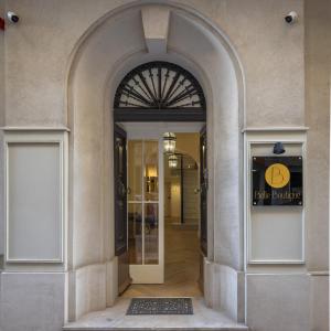 an archway leading into a building with a door at Belle Boutique in Sliema
