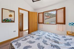 a bedroom with a bed and two windows at La Bella Vista in Buggerru