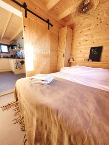 um quarto com uma cama num quarto de madeira em NEW! Tiny House Lantliv Oostkapelle, bij de boer em Oostkapelle