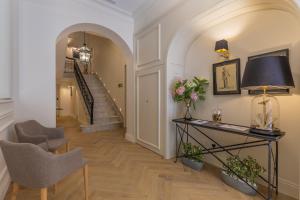 a hallway with a table and chairs and a staircase at Belle Boutique in Sliema