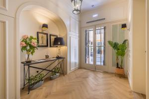 a hallway with a table with flowers and plants at Belle Boutique in Sliema