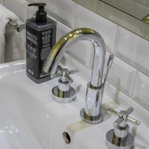 a sink with a faucet and two knobs at Belle Boutique in Sliema