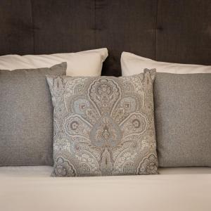 a group of pillows sitting on a bed at Belle Boutique in Sliema