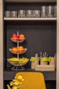 a shelf with three baskets of fruit on it at Belle Boutique in Sliema