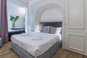 a bedroom with a large white bed in a room at Belle Boutique in Sliema