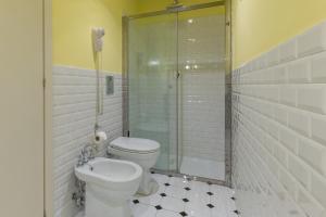 a bathroom with a toilet and a glass shower at Belle Boutique in Sliema
