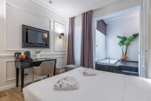 a hotel room with a bed and a desk at Belle Boutique in Sliema