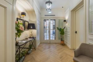 a hallway with a couch and a table with flowers at Belle Boutique in Sliema