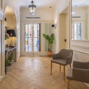 a living room with a chair and a table at Belle Boutique in Sliema