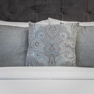 a bed with two pillows on top of it at Belle Boutique in Sliema