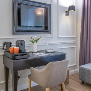 a desk in a room with a chair and a mirror at Belle Boutique in Sliema
