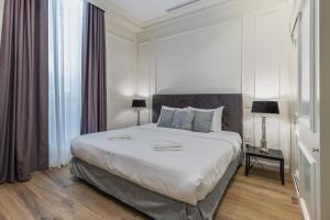 a bedroom with a large white bed in a room at Belle Boutique in Sliema