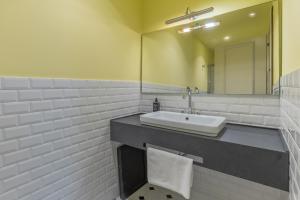 a bathroom with a sink and a mirror at Belle Boutique in Sliema