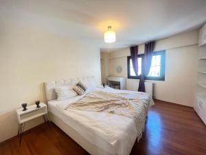 a bedroom with a large white bed and a window at New Studio Apartment, 1BR in Istanbul