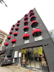 a black building with red windows and red roofs at Port Suites Hotel in Bursa