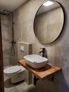 a bathroom with a sink and a toilet and a mirror at Blue of the sea in Krapanj