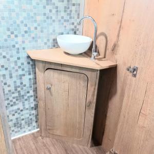 a bathroom with a sink and a bowl on a cabinet at לנפוש על גלגלים in Kefar H̱ananya