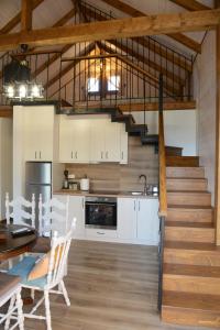 a kitchen and dining room with a staircase in a house at Chalet edelweiss preveza in Preveza