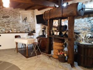 a room with a table and a stone wall at L'antico Frantoio dei nonni in Sestri Levante +15 photos