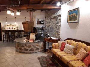 a living room with a couch and a stone wall at L'antico Frantoio dei nonni in Sestri Levante