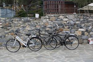 three bikes parked in front of a stone wall at L'antico Frantoio dei nonni in Sestri Levante