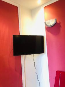 a flat screen tv hanging on a wall at Nights bucharest apartment oldtown in Bucharest
