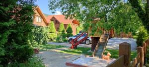 a house with a yard with a tree and a fence at Mini Hotel Zakrut in Tatariv